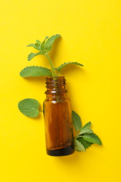 Concept of aromatherapy with mint on yellow background