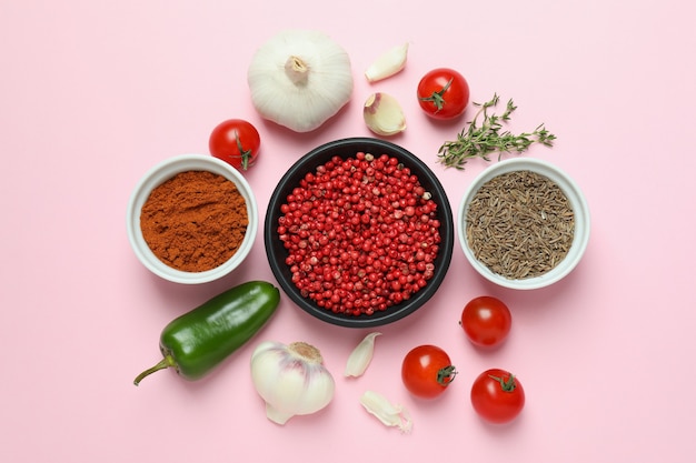 Concept of aromatic spices on pink background