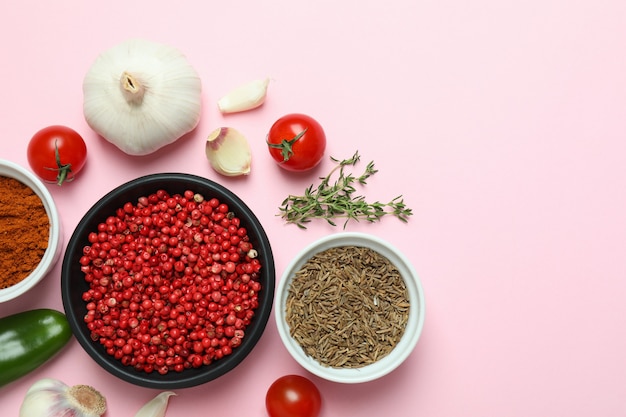 Concept of aromatic spices on pink background