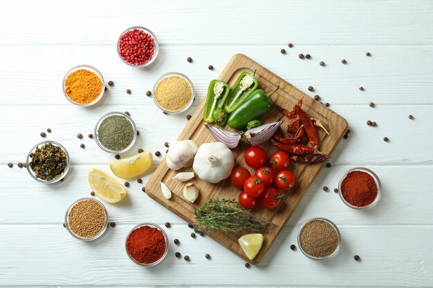 Photo concept of aromatic spices on white wooden table