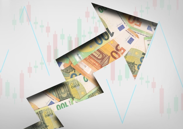 Concept arrow going up for stock trading with euro banknotes and stick candles chartTop view