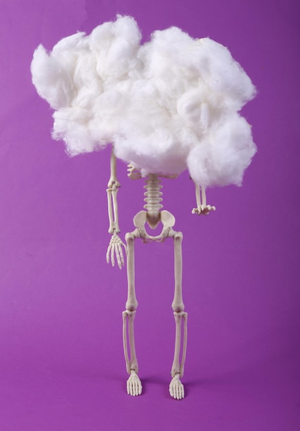 Concept art Skeleton in floating fluffy cloud Purple background Creative idea Minimalism Surrealism