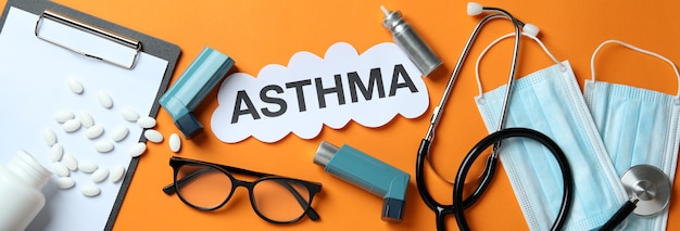 Concept of Asthma treatment on orange background, top view