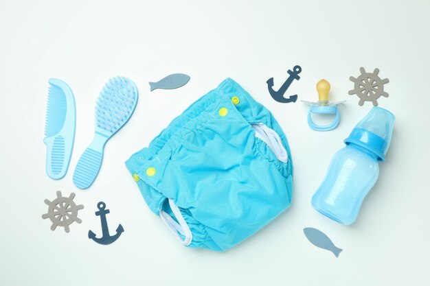 Concept of baby clothes with reusable diapers on white background