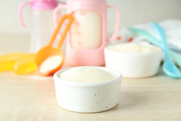 Concept of baby food with ÃÂÃÂowdered milk on wooden table