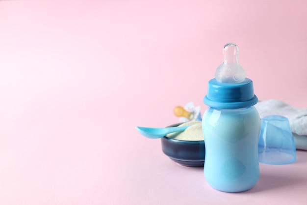 Concept of baby food with ÃÂowdered milk on pink background