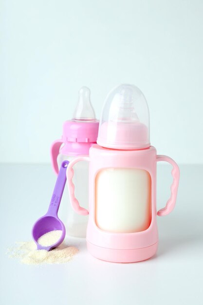 Photo concept of baby food with ãâowdered milk on white table