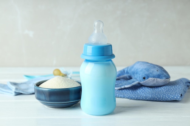 Concept of baby food with ãâowdered milk on white wooden table