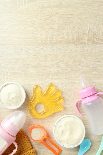 Concept of baby food with ÃÂowdered milk on wooden background