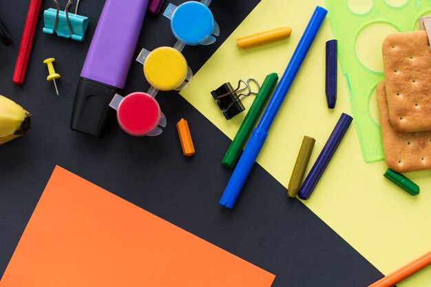 Concept back to school watch chalk line cookies stationery on black background.