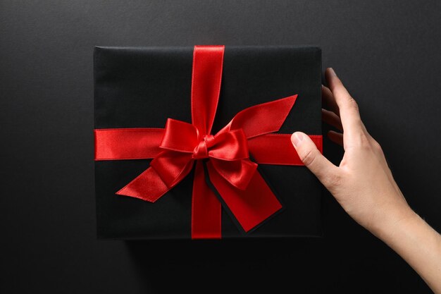 The concept of black friday a gift in a black wrapper