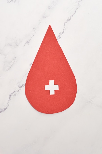 Concept of blood donation Red paper drop icon inviting to donate