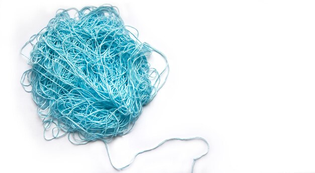 The concept of brainstorming A tangle of mint blue cotton threads needlework yarn Banner copyspace