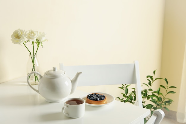 Photo concept of breakfast with blueberry pie on white table