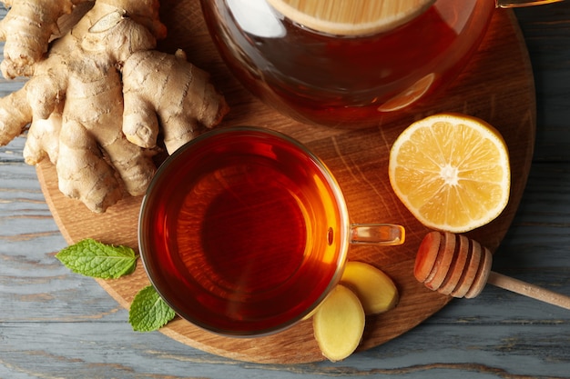 Concept of breakfast with ginger tea on wooden background