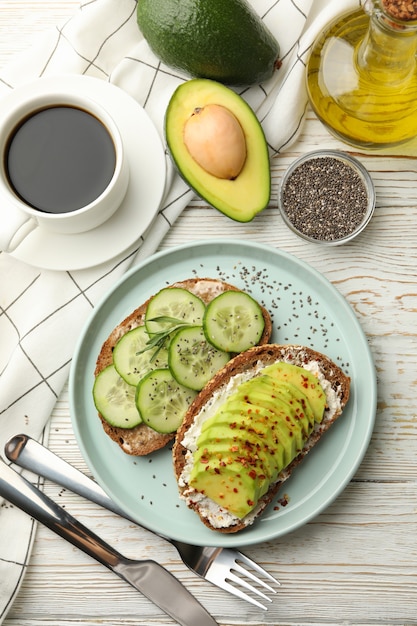 Concept of breakfast with toasts with avocado and cucumber