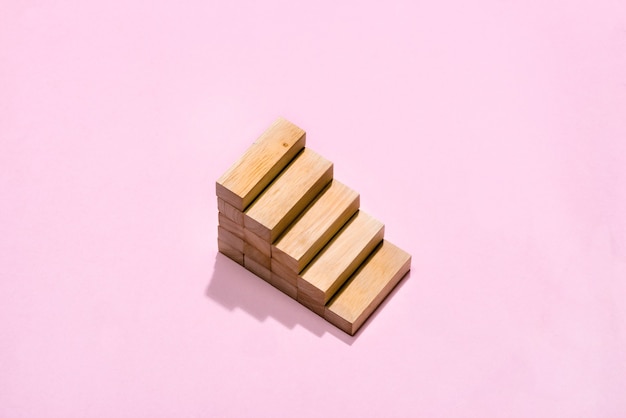 Concept of building success foundation. Wooden blocks in the shape of a staircase