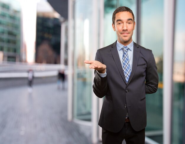 Concept of a businessman showing something with his hand