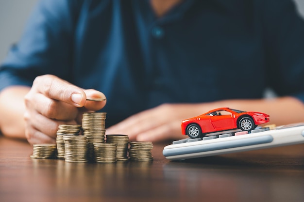 Concept of car insurance business saving buy sale with tax and loan for new car Car toy vehicle with stack coin money on background Planning to manage transportation finance costs loan for car