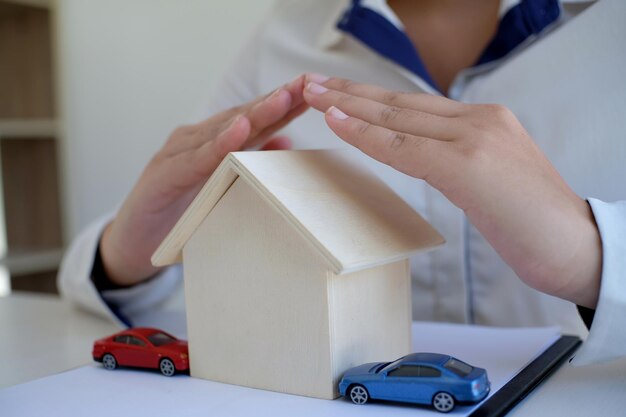 Concept of car insurance with Protection of a car toy car and hand Business concept