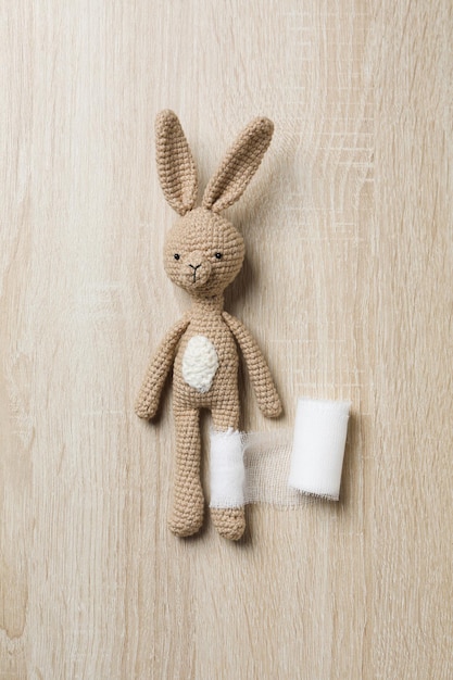 Concept of child injury with bunny with bandage