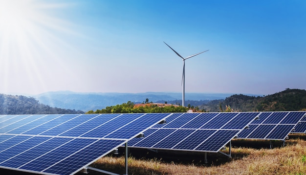 Photo concept clean energy power in nature. solar panel and wind turbine on hill with sunshine