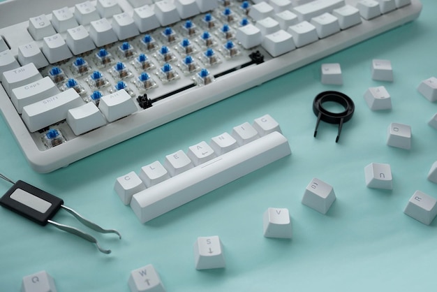 Concept of cleaning disassembled mechanical keyboard game with switch puller and keycaps puller