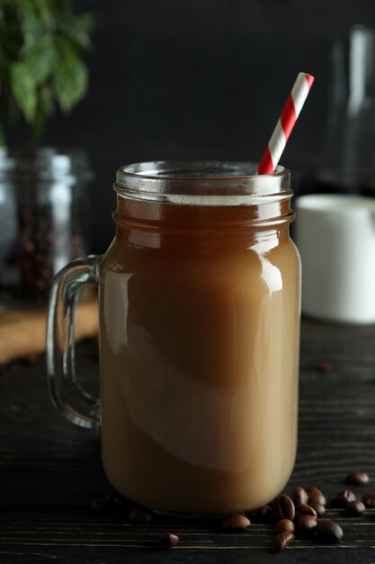 Concept of cold drink with ice coffee on wooden table