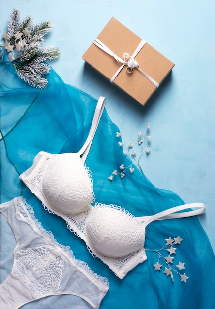 The concept of collecting Christmas gifts, a set of lingerie, fir branches, a gift box