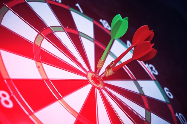 Concept of competition and goal achievementachieving goals in business and lifedartboard with three darts stuck right center of target