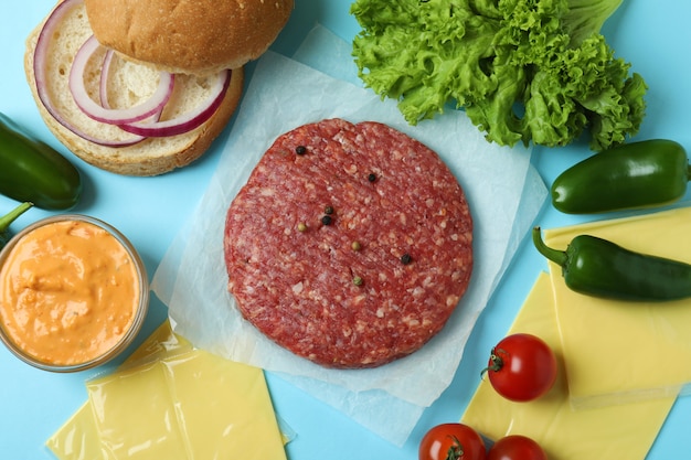 Concept of cooking burger on blue background