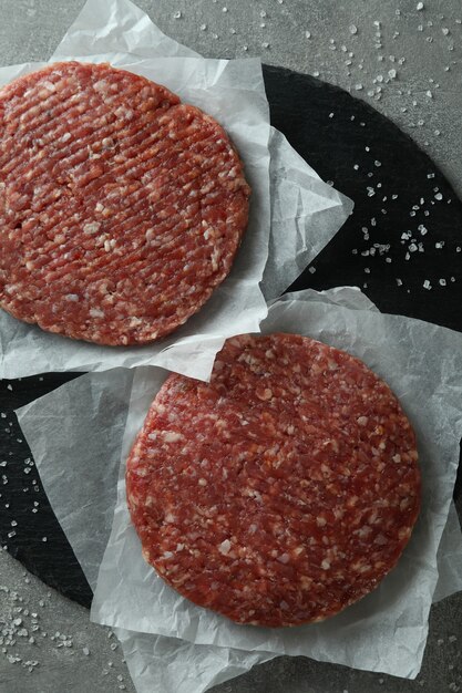 Concept of cooking burger on gray textured table