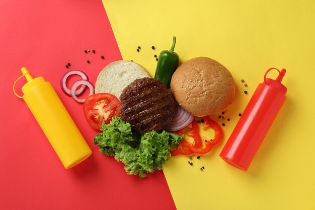 Concept of cooking burger on two tone background