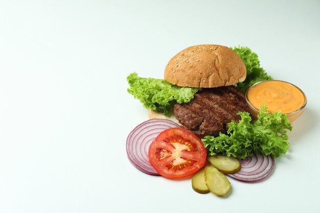 Concept of cooking burger on white background