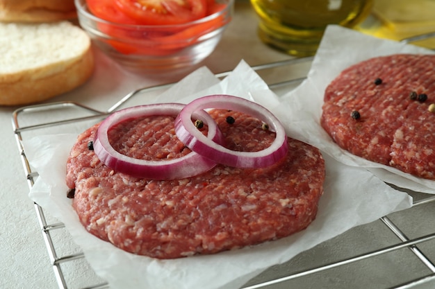 Concept of cooking burger on white textured table