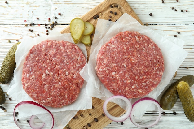 Concept of cooking burger on white wooden table