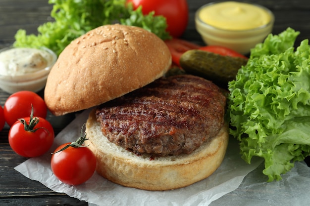 Concept of cooking burger on wooden table