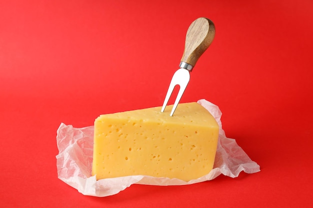 Concept of cooking eating with hard cheese on red background