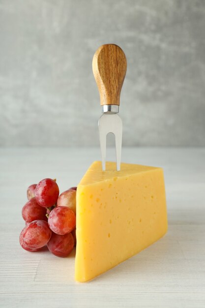 Concept of cooking eating with hard cheese on white wooden table