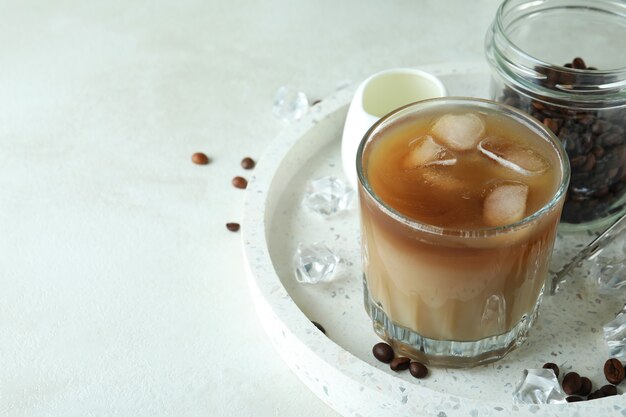 Concept of cooking ice coffee on white textured table