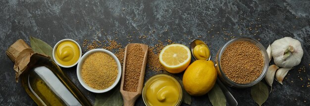 Concept of cooking mustard on black smoky background, top view