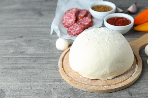 Concept of cooking pizza on gray wooden background