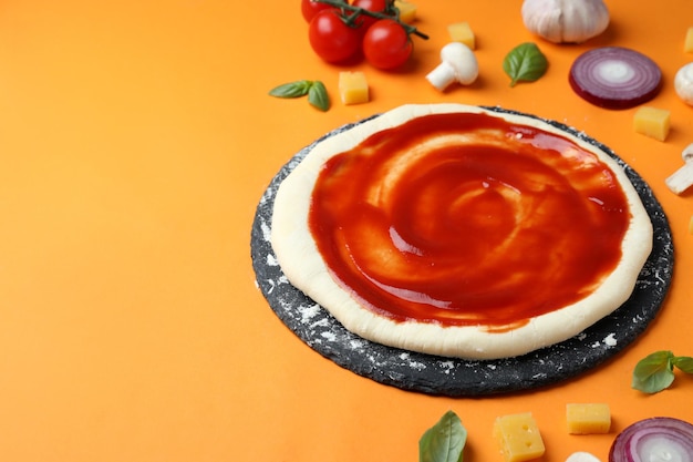 Concept of cooking pizza on orange background