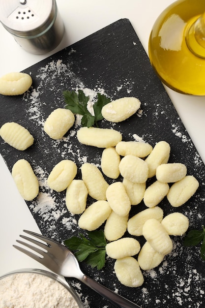 Concept of cooking potato gnocchi on white background