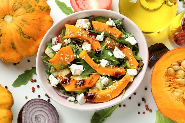 Photo concept of cooking pumpkin salad on white background