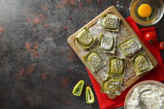 Photo concept of cooking ravioli on dark background