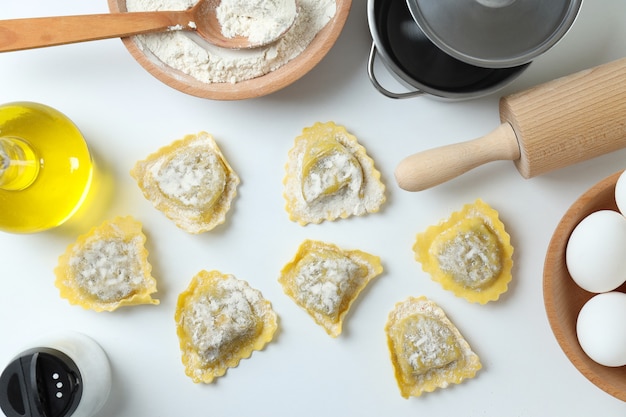 Concept of cooking ravioli on white background