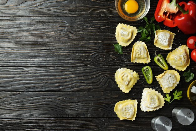 Concept of cooking ravioli on wooden background