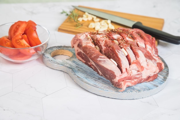 The concept of cooking raw pork meat at home . Raw pork meat on a wooden chopping board