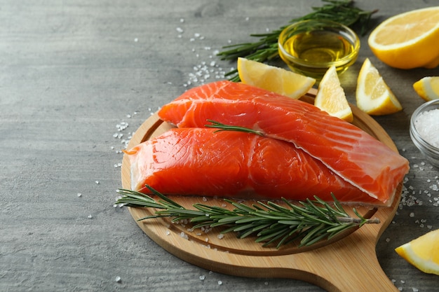 Concept of cooking salmon on gray textured table